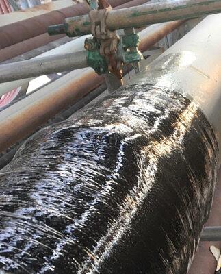 Black composite reinforcement applied to industrial piping