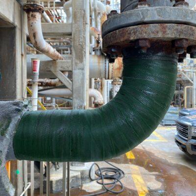 Green composite wrap around a pipe elbow